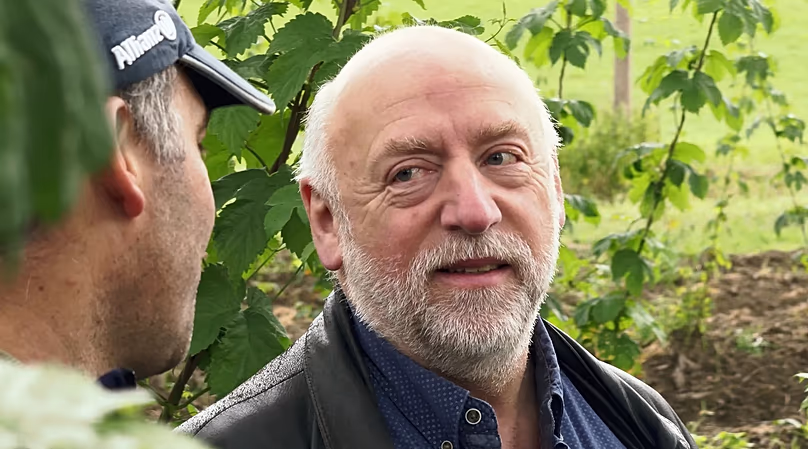 Engineer Bernhard Gruber talking to hop farmer Josef Wimmer.