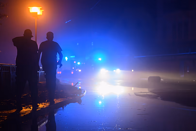 Police officers stand near to a police vehicle in front of a house in Leipzig Connewitz, 24 April, 2024