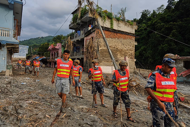 Workers clear debris in the aftermath of a flash flood in the Devighat area of Nuwakot district in Nepal, 28 August, 2026
