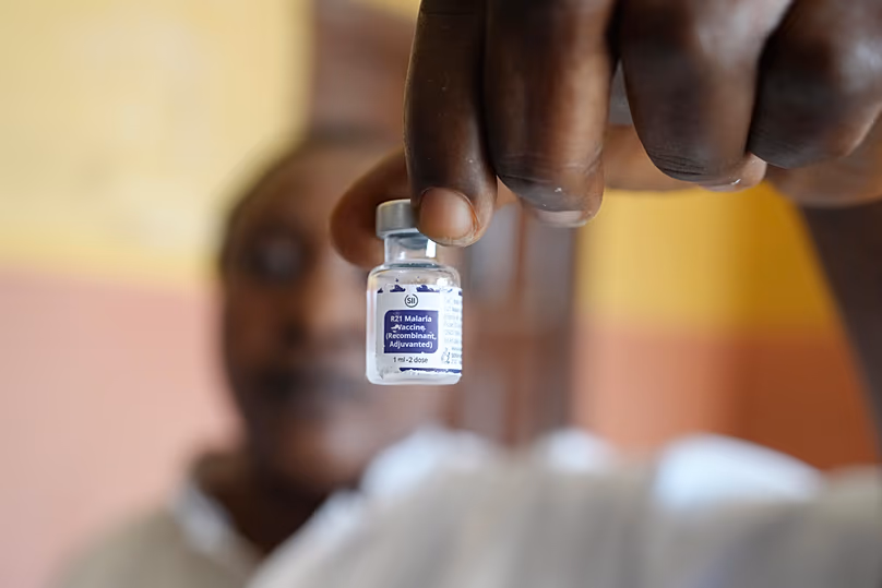 A health worker shows a bottle of the malaria vaccine R21/Matrix-M before administering it in Yenagoa, 9 December, 2024