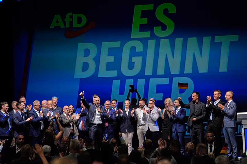 Top AfD candidate Ulrich Siegmund speaks in front of a reading "it starts here" at an AfD election party in Magdeburg, 6 September, 2026
